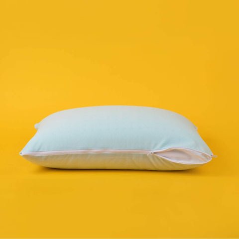 The zipper opened partially on the Slumber Cloud Adjustable UltraCool Pillow on a cream background