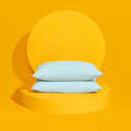 The Slumber Cloud UltraCool Pillow stacked on a yellow pedestal