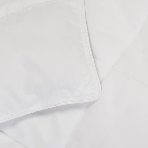 A detailed view of the corner tie on a Slumber Cloud Comforter.