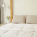 A clean bedroom with Slumber Cloud Comforter and pillows