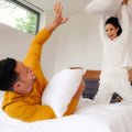 A couple pillow fighting with Slumber Cloud Core Down Alternative Pillow