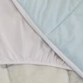 A close up shot of the Slumber Cloud Essential Mattress Pad made with Outlast temperature regulation technology.